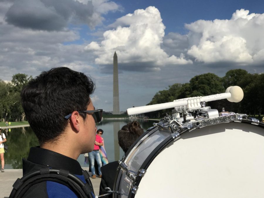 Bass percussionist Marcos Buzzato overlooks the pond of the Washinton Monument. (Photo courtesy of Jason Graf)
