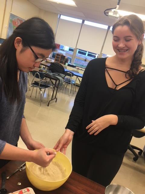 Junior Joanna Chen and sophomore Jackie Boden mixing ingredients for their banana bread. (Photo Courtesy of Teresa Fahy).