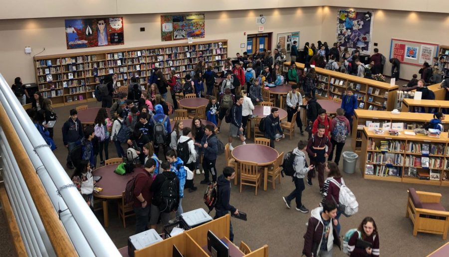 At the beginning of each school day, students can be seen picking up their respective Chromebooks. Once the school day is over, students put their laptops back in the library where they are stored, ready to be used again for the next day. (Photo by Aidan McHenry) 