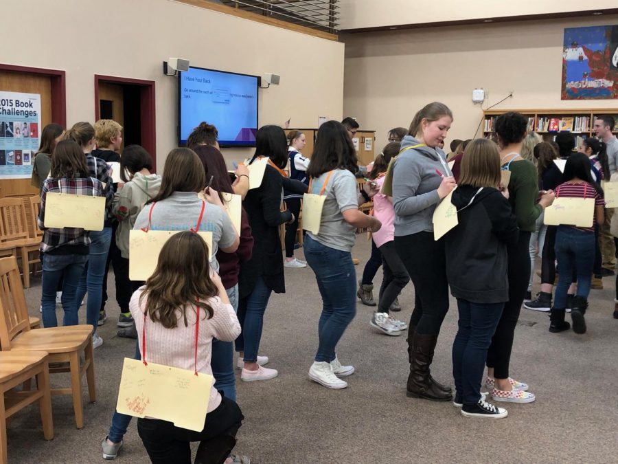The last activity of the day was called, “I Have Your Back.” Pieces of thick folder covers were hung on everyone’s backs. Everyone went around giving compliments and writing down only nice things. (Photo courtesy of Penny Giamoni)
