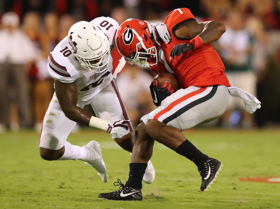 Leo Lewis, a Mississippi State football player who was the key informant in the Ole Miss-Mississippi State scandal, tackles Georgia running back D’Andre Swift in September 2017 amidst the peak of the case. 
(Photo Courtesy of Curtis Compton/Atlanta Journal-Constitution/TNS)