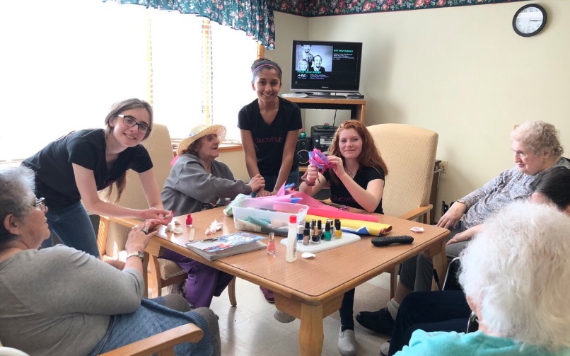 In early May, Warren Hills’ chapter of Glamour Gals visited Warren Haven Nursing Home in Oxford, NJ, as part of their monthly makeover sessions offered to nursing home residents. During their May visit, volunteers made flowers out of tissue paper with the residents to celebrate Spring. “I loved making flowers with the seniors at Warren Haven. The most rewarding part of the whole thing was seeing their faces light up after we made the flowers for them,” said junior Jessica Kara. Pictured above are seniors Elizabeth Donnelly, President, Danielle Marzigliano, Vice President, and Gigi Ali, Secretary. (Photo Courtesy of Julia Henning)