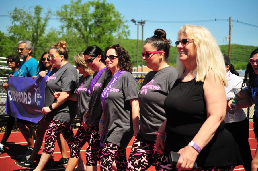 Relay for Life participants walk in the survivor/caregiver lap. (Photo by Elisha Stenger) 
