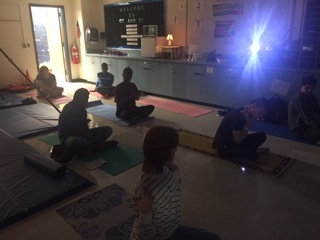 Students in yoga positions during an Adaptive Yoga for Health and Mindfulness session. (Photo by Aaliyah Khan). 
