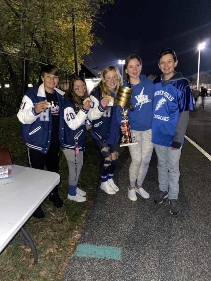 Warren Hills Student Council representatives proclaim victory in the “Battle of the Food Banks” competition during the long-awaited Warren Hills vs. Hackettstown High School rivalry football game Nov. 2. Although Hackettstown won the football game 48-21, Warren Hills collected the most cans of food. The food donated to Warren Hills will be passed on to the school’s Health Office for its work with Helping Hands, and Hackettstown officials donated their food to Lords Pantry at Trinity United Methodist Church. Combined, the food donation totaled more than 700 cans. Student Council officials celebrating their win are (left to right) Walker Heller, Junior Class representative; Secretary Kaitlyn Marsh; Vice President Heather Laffan; President Jess Howley; and Jack Meyer, Sophomore Class representative. (Photo courtesy of Student Council Adviser Emily Kablis)