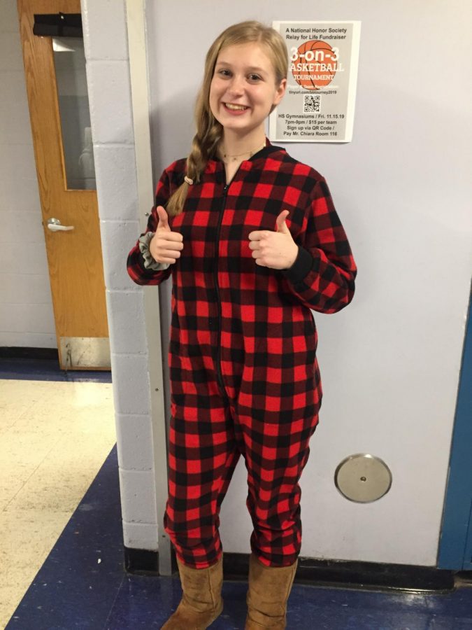 Junior Emily Kovacsy offers two thumbs-up in favor of wearing pajamas to school in support of the recent DECA Good Grief fundraiser. Students and staff members paid $1 to wear either pajamas, a hat or blue jeans to school on Tuesday, Nov 5. Good Grief is a New Jersey Statewide Community Service Project meant to teach students “business skills, and also serve their community and society as a whole,” according to the New Jersey DECA website. The proceeds from this fundraiser go to Good Grief, which provides a variety of free support for those who have lost loved ones. The Warren Hills event raised $312. Students in English Teacher Emily Kablis’ homeroom were recognized for recording the highest participation rate on Good Grief day. (Photo by Samantha Lewis)