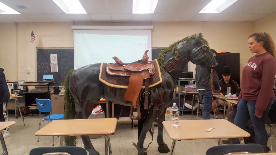 For English Teacher Emily Kablis’ public speaking class this year, students were assigned to write and present a How-To Speech. For Sarah Chaplain, this meant bringing in her life-size horse statue to show her classmates how to tack up Western style. Chaplain and her father built the lifelike model along with three others, all of which are built to size. Each of her horses was designed with a certain magical creature in mind. The one she brought to class was a Threstral, but back at home, she also has a unicorn, Pegasus and water kelpie. Chaplain has been riding for practically her entire life, and she has her own, living horse, as well. Her father, an elevator mechanic, added features such as glowing eyes, moving heads, and flapping wings. It’s no wonder that Chaplain got an A on her speech. (Photo by Sarah Hale)