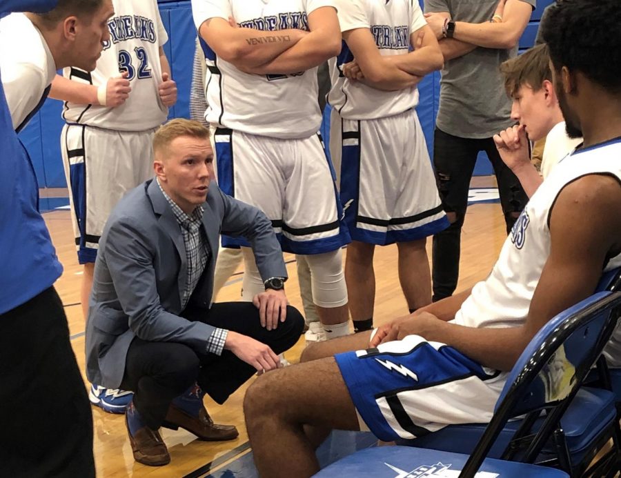 Head coach Joseph Bamford makes in-game adjustments during a timeout in the boys basketball team’s season opener against Somerville. 