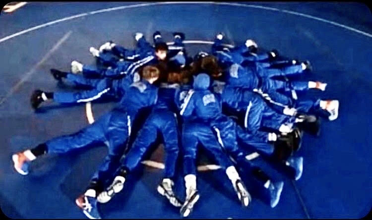 Boys wrestlers huddle to discuss strategy after doing their pre-match routine at the Hills/Hillsborough match in mid-December.  (Photo courtesy of Stephen Malia)