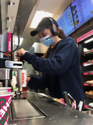 Ellie Kachala, a Warren Hills junior, prepares a customers drink at Dunkin, where she works when she is not in school or at Swimming Team practice. 