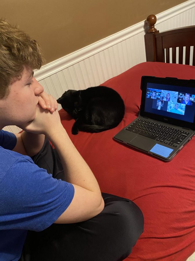 Warren Hills sophomore Ryan Cagnassola and his cat watch the Drama Club’s fall play, Do You Read Me?, from the comfort of their home. 

