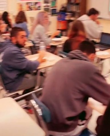 Students from three Journalism classes enjoy and rate pizzas in Room 113 in December. (Photo courtesy of Loren Burrows)