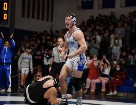 Senior Tyler McCatharn flexes towards the crowd after pinning Luca Salvatoriello of West Essex in the Sectional Final.
 (Photo Courtesy of Alexandra Balaney)
