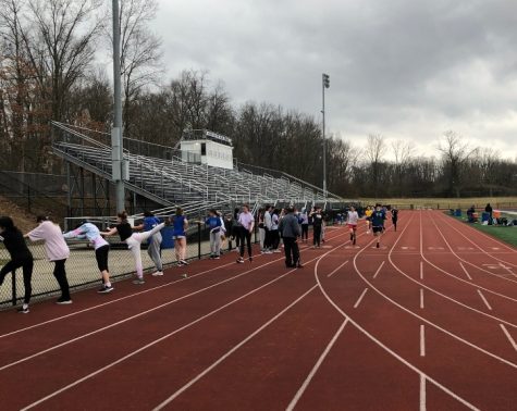 Under ominous clouds, runners of the Warren Hills Track and Field Team warm up April 2 before their first multi-team home meet of the 2022 track season. Practices began in early March, and on April 2 the athletes were able to participate in an official meet. The boys’ and girls’ teams were led by boys’ Captain Ryan Shulman and girls’ captains Grace Tirabassi and Erin Carroll, all seniors. Both Tirabassi and Carroll placed in their events. Carroll took second place in the 200-meter run, and Tirabassi placed third in the 1600-meter run and second in the 3200-meter race. Overall, the girls placed fourth in the meet and the boys finished in fifth. Team members have high hopes for the rest of the season and hope their hard work in preseason pays off. “I’m excited for the teams performance this upcoming track season,” said junior runner Bridget McGrath. “Everyone has been working very hard and I hope for lots of personal records this season.” (Photo by Bailey Thompson)