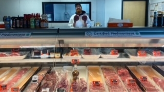 Butcher Richard “Rick” Hall works behind the meat case at Arctic Foods Meat Shoppe and Specialty Market.