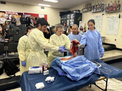Students Jonathan Lainez, Allison Groelly and Carly Roth get involved in the dissection of an upper limb as “scrub-ins” with Dr Nicholas Avallone.