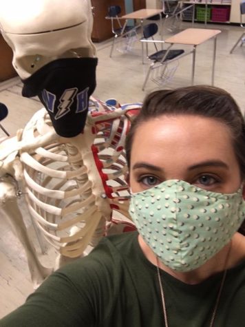 Alexandra Helle and her skeleton prop are masked up and ready to teach Anatomy and Physiology! Helle said that the photo “sums up teaching through COVID.”