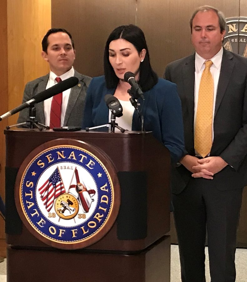 Flanked by two Florida state legislators, political activist Laura Loomer speaks in Tallahassee, Fla., about a bill seeking to stop social media censorship.