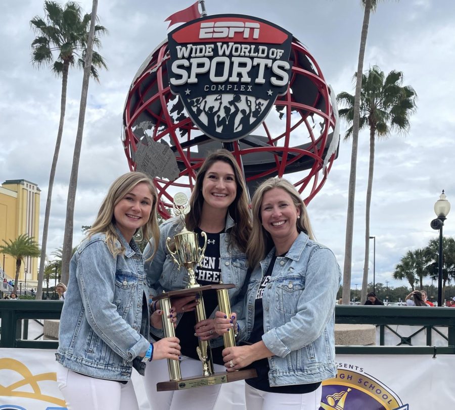 Warren Hills Cheerleading Coaches pose with the team’s 4th-place finals trophy won at the High School National Cheerleading Championship in Orlando, Florida in February, 2022.  According to Head Coach Kimberlee Sweet, the team aims to outdo themselves at this year’s competition.   Pictured left to right are Morgan Reiner, Corinne Marsan and “Kimmy” Sweet. 
(Photo courtesy of Kimberlee Sweet)