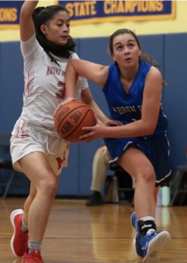 Warren Hills girls’ basketball standout Meredith Dufner drives past a Mount Saint Mary opponent. (Photo courtesy of Mount Saint Mary Academy, Watchung)