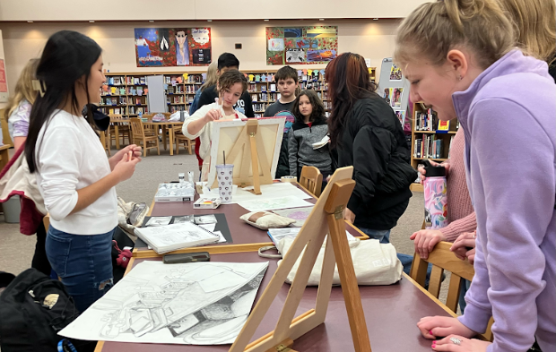 Numerous sixth grade students from four local elementary schools gathered around tables where high school students had their visual arts work displayed. The presentation of artwork in the library was just one part of the eventful Fine Arts Showcase.
(Photo by Allison Slovak)