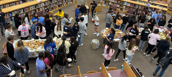 About 80 students mingle in the high school library as part of the annual Best Buddies “Breakfast and Board Games” event Oct. 17. (Photo by Brynn Nemeth)
