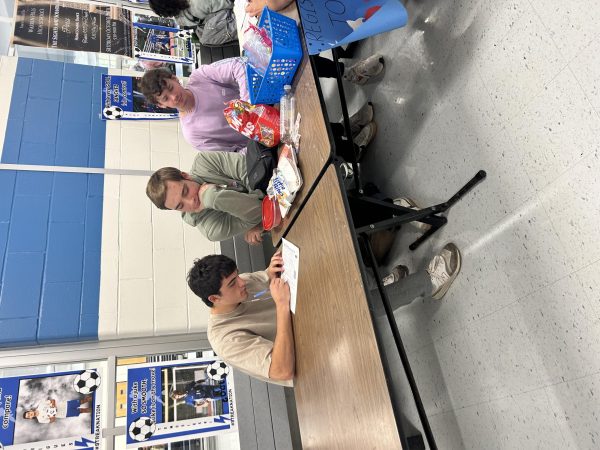 Seniors Max Howley, Brian Collum, Logan Young register the students of Warren Hills to vote in upcoming elections. Wednesday, Thursday, and Friday students got the opportunity to register to vote during their lunch periods. This event was set up by Debre Rokosny, the Advanced Placement Government and Politics teacher as well as the advisor for the human rights club. Although many students are not old enough to vote in the 2024 Election, since you can still register at 17, many students were interested and thought this was great because once you register once it is not something you have to worry about again. Overall the turnout was great with over 50 students registered and ready to get their voices heard. (Photo by Shelia Bazelais).

