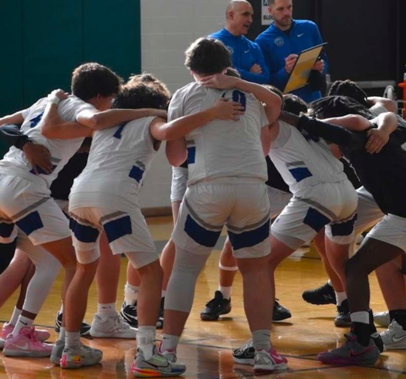 The varsity basketball team huddles before a game (Photo courtesy of Dawn Nisivoccia)