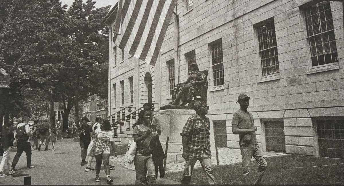 People walk near the John Harvard statue at Harvard University in Cambridge. (Photo courtesy of MCT)