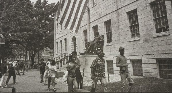 People walk near the John Harvard statue at Harvard University in Cambridge. (Photo courtesy of MCT)